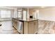 Bright kitchen boasts granite counters, an island with sink, stainless steel appliances, and an open floor plan at 5205 Raging Creek Dr # 122, Indian Trail, NC 28079
