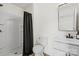 Bathroom features a shower with black curtain, toilet, and white vanity with black faucet at 5740 Crouse Rd, Crouse, NC 28033