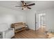 Bright Bedroom featuring a wooden crib, neutral glider, wood-look flooring, and modern ceiling fan at 5740 Crouse Rd, Crouse, NC 28033