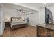 Warm bedroom featuring a ceiling fan, wood-look flooring, and sliding barn door at 5740 Crouse Rd, Crouse, NC 28033