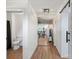 Hallway has luxury vinyl plank, open concept sightlines, neutral paint and modern fixtures at 5740 Crouse Rd, Crouse, NC 28033