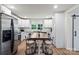 Kitchen with stainless steel appliances, white cabinetry, and a central dining table with seating at 5740 Crouse Rd, Crouse, NC 28033