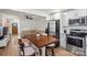Kitchen with stainless steel appliances and a dining table, opening into a living room area at 5740 Crouse Rd, Crouse, NC 28033