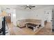 Bright living room with a neutral-colored couch, ceiling fan, and access to other rooms at 5740 Crouse Rd, Crouse, NC 28033