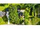Aerial view of a landscaped property featuring a charming home, green lawn and driveway at 5811 Gettysburg Dr, Concord, NC 28027