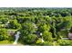 Aerial view of a house surrounded by lush trees, with a long driveway and verdant landscape at 5811 Gettysburg Dr, Concord, NC 28027