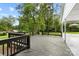 Spacious wooden back deck with black railing overlooking the backyard and mature trees at 5811 Gettysburg Dr, Concord, NC 28027