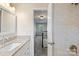 View of the bathroom showing the vanity and shower with beautiful tile work and marble countertop at 5811 Gettysburg Dr, Concord, NC 28027