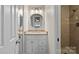 Bathroom featuring a tiled shower, mirror, vanity and sink with granite countertop at 5811 Gettysburg Dr, Concord, NC 28027