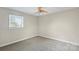 A bedroom featuring gray carpet, neutral walls and a ceiling fan with a light fixture at 5811 Gettysburg Dr, Concord, NC 28027
