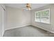 Bedroom featuring a ceiling fan and a large window that brings in natural light to the room at 5811 Gettysburg Dr, Concord, NC 28027