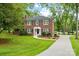Charming two-story brick home with a manicured lawn and classic black shutters and trim at 5811 Gettysburg Dr, Concord, NC 28027
