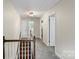 A bright hallway featuring neutral paint, plush carpeting, and access to multiple rooms at 5811 Gettysburg Dr, Concord, NC 28027