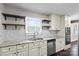 This kitchen boasts white cabinets, stainless steel appliances, and granite counters, and a window over the sink at 5811 Gettysburg Dr, Concord, NC 28027