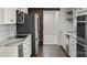 This modern kitchen features granite countertops, stainless steel appliances, and a sliding barn door at 5811 Gettysburg Dr, Concord, NC 28027