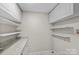 Laundry room with granite countertop, ample shelving, white cabinets and marble floor at 5811 Gettysburg Dr, Concord, NC 28027