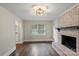 Comfortable living room with a fireplace, hardwood floors, and neutral paint at 5811 Gettysburg Dr, Concord, NC 28027