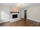 Inviting living room featuring a brick fireplace and hardwood floors at 5811 Gettysburg Dr, Concord, NC 28027
