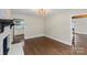 Cozy living space featuring hardwood floors, a brick fireplace, and an open layout to the kitchen at 5811 Gettysburg Dr, Concord, NC 28027