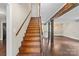 Wooden staircase with exposed beams leads to a bright, open living space upstairs at 5811 Gettysburg Dr, Concord, NC 28027