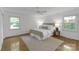 Bright bedroom with hardwood floors, large windows, ceiling fan, and neutral decor at 629 Wingrave Dr, Charlotte, NC 28270