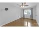 Spacious bedroom with hardwood floors, ceiling fan, neutral walls, and natural light at 629 Wingrave Dr, Charlotte, NC 28270