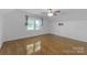 Bedroom with hardwood floors, ceiling fan, neutral walls, and natural light at 629 Wingrave Dr, Charlotte, NC 28270
