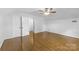 Bright bedroom featuring hardwood floors, ceiling fan, and natural light at 629 Wingrave Dr, Charlotte, NC 28270