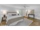 Bedroom with hardwood floors, neutral walls, and a view to an ensuite bathroom at 629 Wingrave Dr, Charlotte, NC 28270