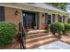 Inviting front entrance with brick steps, iron railings, and decorative plants at 629 Wingrave Dr, Charlotte, NC 28270