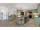 Open concept kitchen with an island and dining area offers ample space for entertaining at 629 Wingrave Dr, Charlotte, NC 28270