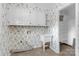 Charming laundry room with floral wallpaper, white cabinets, and utility sink at 629 Wingrave Dr, Charlotte, NC 28270
