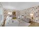 Bright and airy living room with elegant wallpaper, plush seating, and hardwood floors at 629 Wingrave Dr, Charlotte, NC 28270
