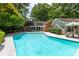Inviting in-ground pool surrounded by lush landscaping and a patio area at 629 Wingrave Dr, Charlotte, NC 28270