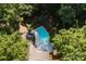 Aerial view of a private backyard pool surrounded by mature trees and garden at 629 Wingrave Dr, Charlotte, NC 28270