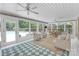 Inviting sunroom with checkered tile floors, ample seating, and a view of the pool at 629 Wingrave Dr, Charlotte, NC 28270