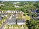 Aerial view of gray townhomes and community near lush trees, parking lots and Charlotte skyline at 7012 Bryce Ave, Charlotte, NC 28217