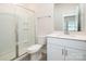 Well-lit bathroom with a shower, sleek toilet, and a modern vanity with storage at 7012 Bryce Ave, Charlotte, NC 28217