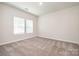 Bright bedroom featuring large windows, offering plenty of natural light and a cozy atmosphere at 7012 Bryce Ave, Charlotte, NC 28217