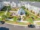 Overhead view of an outdoor seating area with tables, mature trees, manicured shrubs, and a parking lot at 7012 Bryce Ave, Charlotte, NC 28217