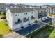 Aerial view showcasing modern townhomes with garages and balconies, set in a suburban community at 7012 Bryce Ave, Charlotte, NC 28217