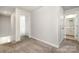 Hallway leading to bedrooms and bathrooms, enhancing the home's spacious and open layout at 7012 Bryce Ave, Charlotte, NC 28217