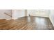 Spacious living area with hardwood floors, staircase to upper level, and abundant natural light from the large windows at 7012 Bryce Ave, Charlotte, NC 28217