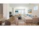 Bright, staged living room with wood floors, comfortable seating, and large windows that bring in natural light at 7012 Bryce Ave, Charlotte, NC 28217