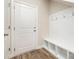Entryway featuring a built-in bench with storage cubbies and convenient coat hooks at 7012 Bryce Ave, Charlotte, NC 28217