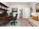 Cozy office space featuring a desk, a comfortable chair, and a view of a bathroom through an open doorway at 7012 Bryce Ave, Charlotte, NC 28217