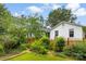 This backyard features mature trees, lush green grass and a charming wooden fence at 805 S Main St, Mount Holly, NC 28120