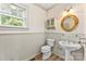 Bathroom with pedestal sink and decorative mirror at 805 S Main St, Mount Holly, NC 28120