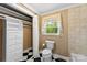 Bathroom with tile floors, toilet, and window with an outside view at 805 S Main St, Mount Holly, NC 28120