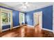 Spacious bedroom with hardwood floors and two large windows, showcasing views into connecting rooms at 805 S Main St, Mount Holly, NC 28120